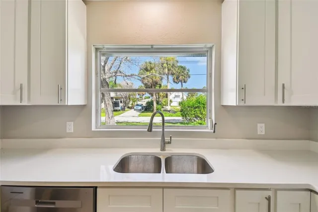 a kitchen with a sink and a window