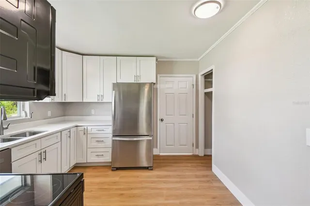 a kitchen with wooden cabinets and stainless steel appliances
