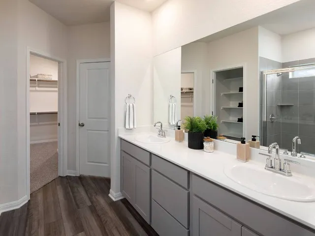 a bathroom with a double vanity sink and mirror