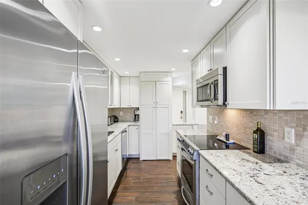 a kitchen with a sink stove and refrigerator