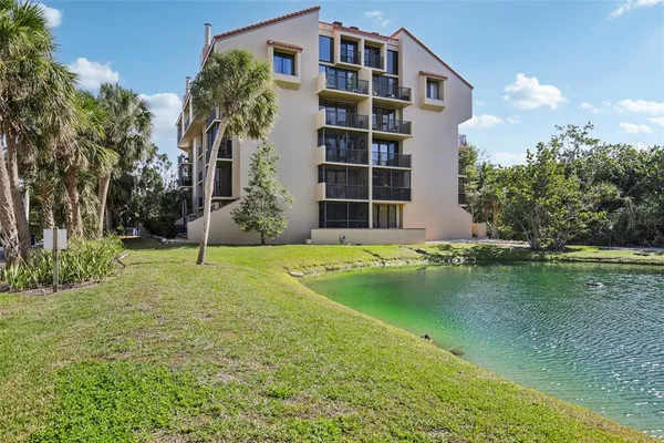 a swimming pool with yard and trees in the background