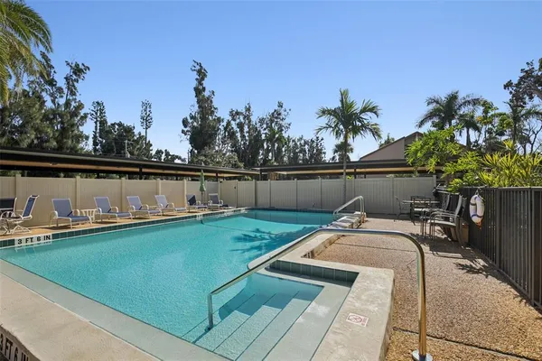 a view of a swimming pool with a yard and sitting area