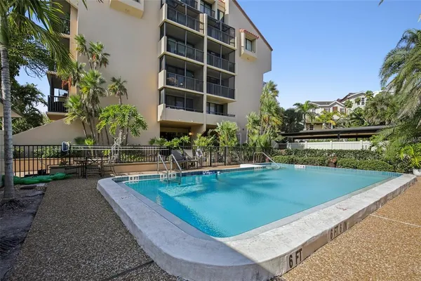 a view of a swimming pool with a patio and a yard