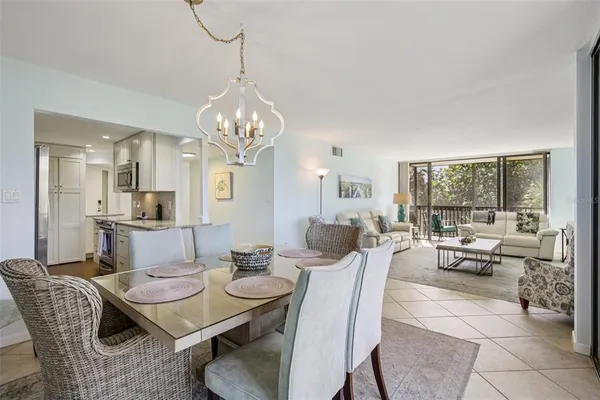 a view of a dining room with furniture wooden floor and chandelier