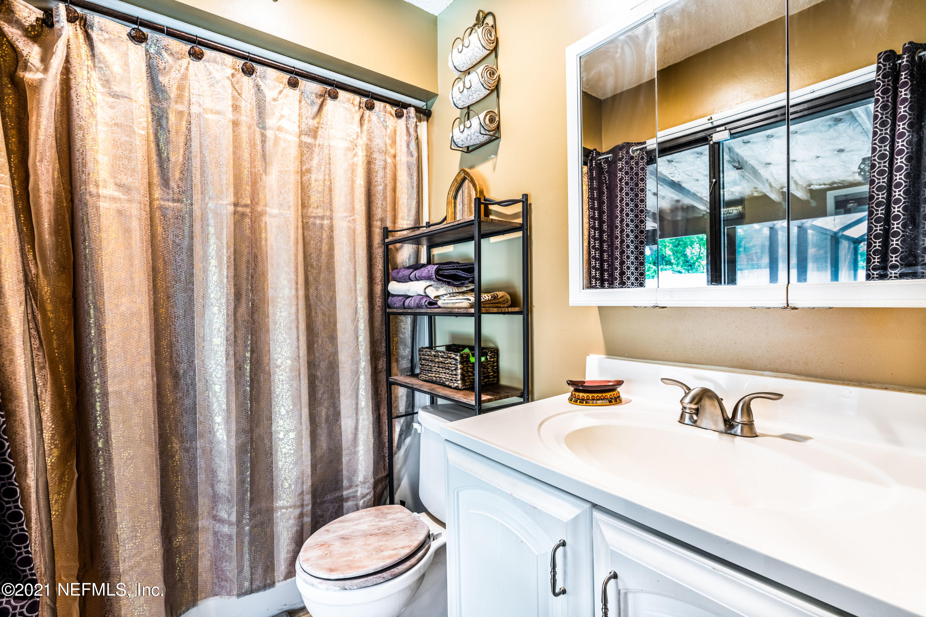 215 Harvard Road St. Augustine, FL 32086 - Photo 23 of 42 a bathroom with a sink a toilet and a mirror
