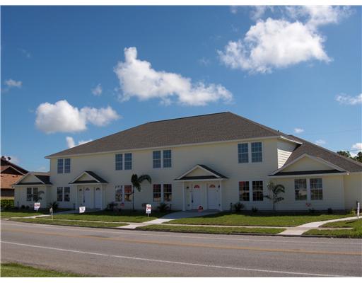 a view of a big house in middle of the road