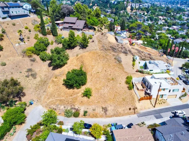 an aerial view of a house with a yard and lake view