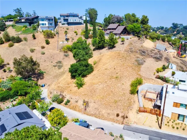 an aerial view of a house with a yard and trees