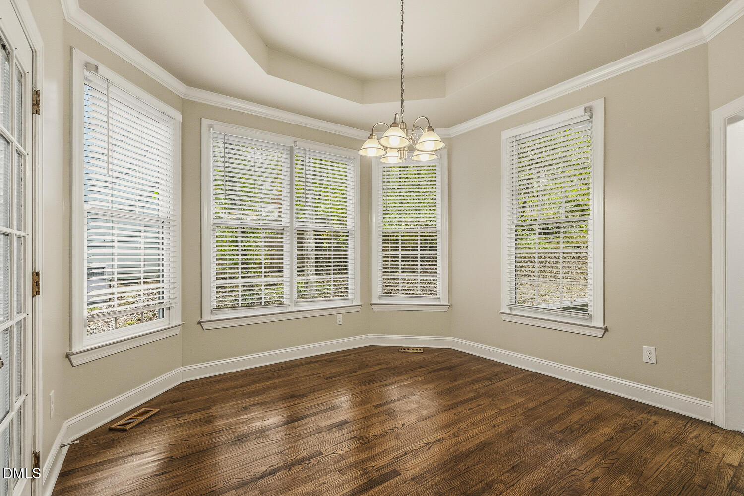 1006 Barnford Mill Road Wake Forest, NC 27587 - Photo 12 of 40 a view of an empty room with wooden floor and a window