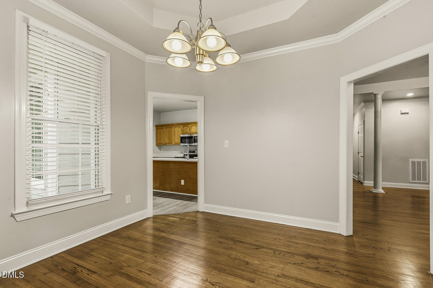 1006 Barnford Mill Road Wake Forest, NC 27587 - Photo 14 of 40 an empty room with wooden floor cabinet and windows