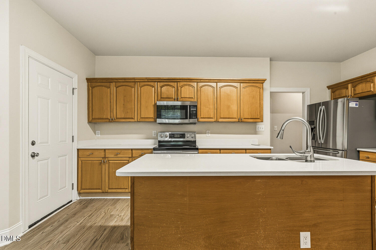 1006 Barnford Mill Road Wake Forest, NC 27587 - Photo 16 of 40 a kitchen with stainless steel appliances a sink a stove and a refrigerator with wooden floor