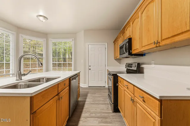 a kitchen with stainless steel appliances a sink and a stove