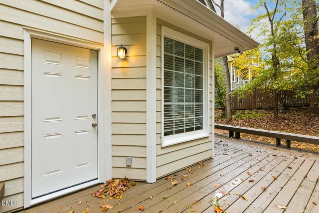 a view of swimming pool with lawn chairs and plants