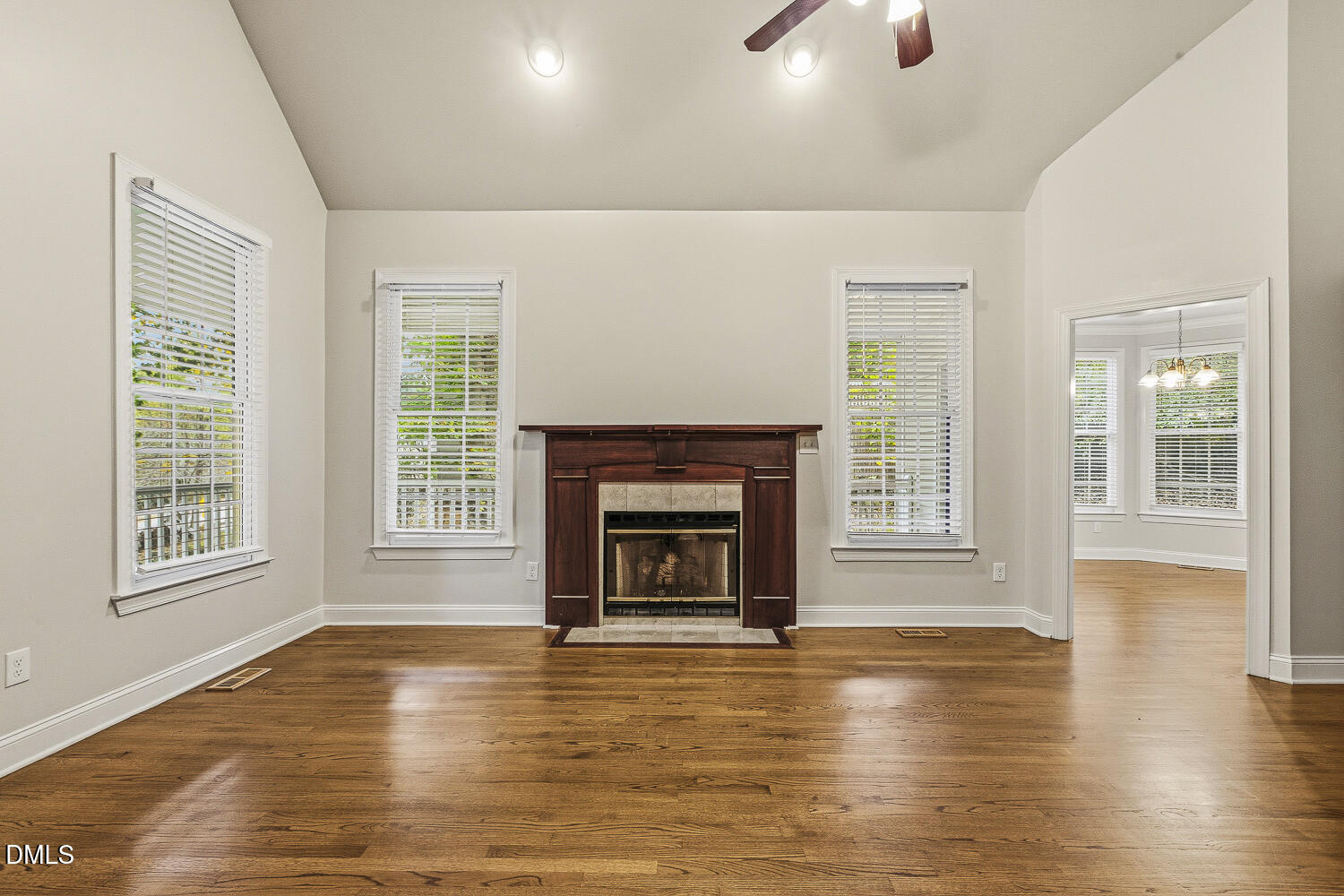 1006 Barnford Mill Road Wake Forest, NC 27587 - Photo 8 of 40 a view of an empty room with window fireplace and wooden floor