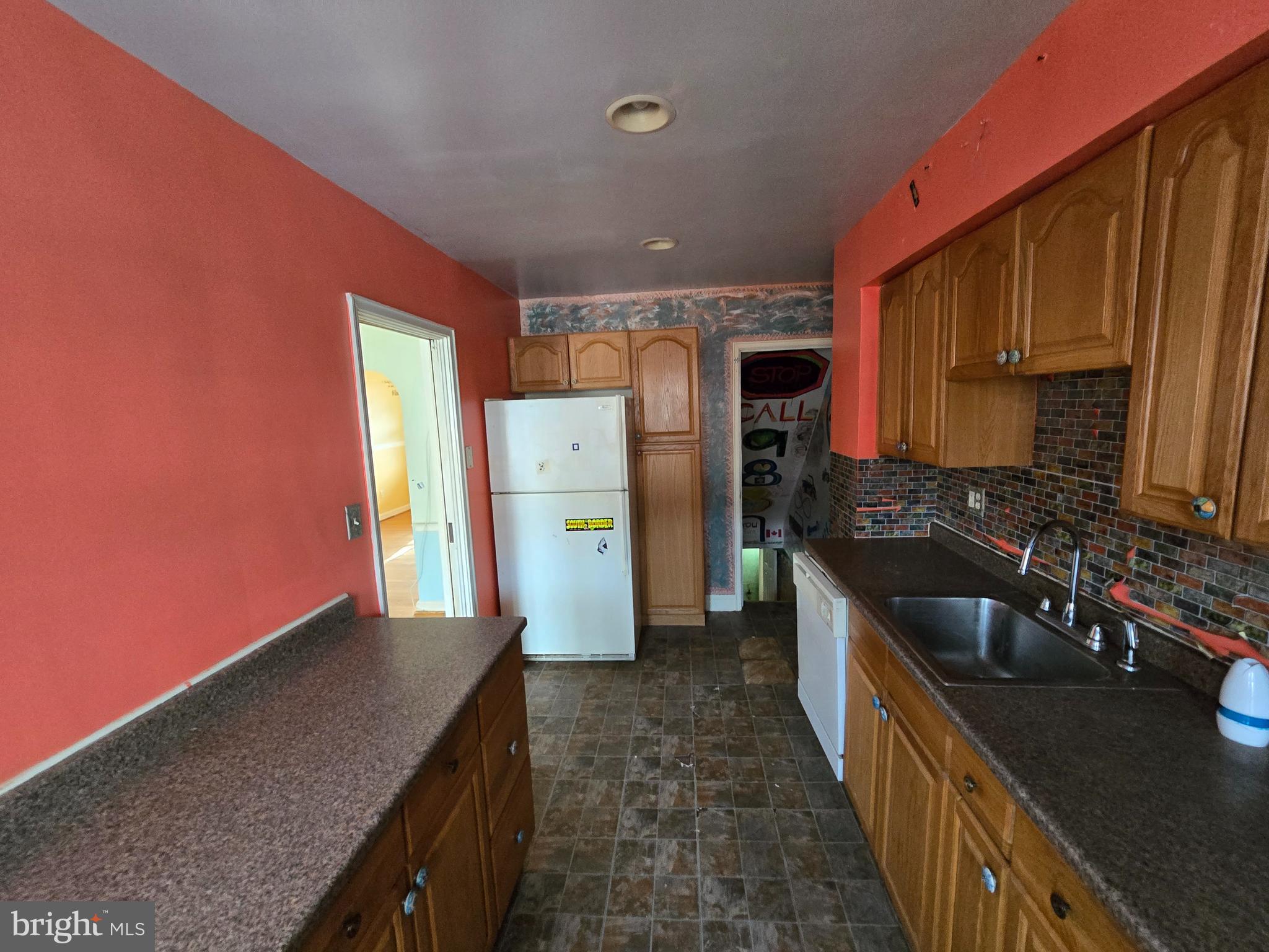 1708 Hartsdale Road Baltimore, MD 21239 - Photo 11 of 26 a kitchen with refrigerator and cabinets