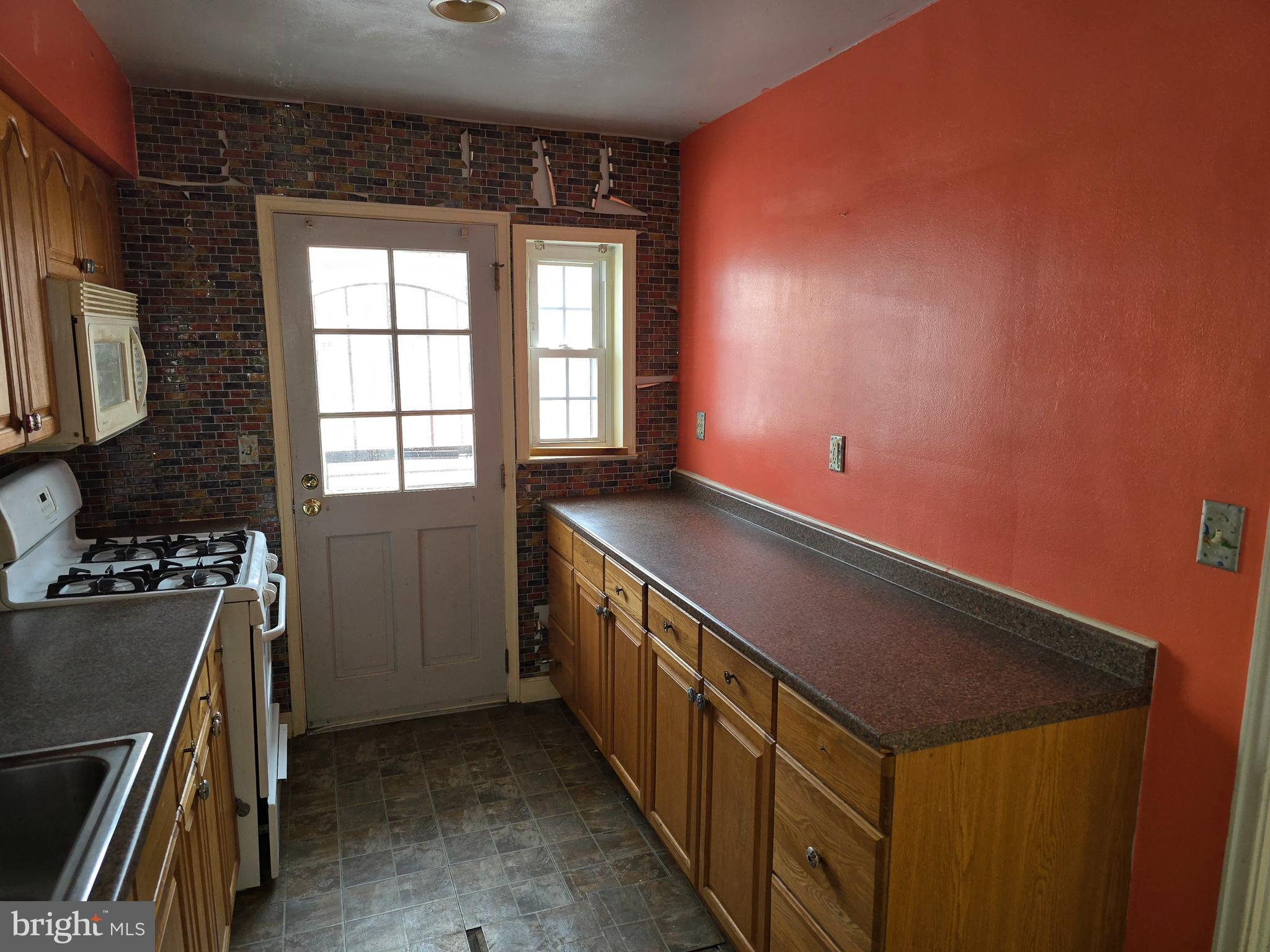 1708 Hartsdale Road Baltimore, MD 21239 - Photo 12 of 26 a kitchen with a refrigerator and a stove