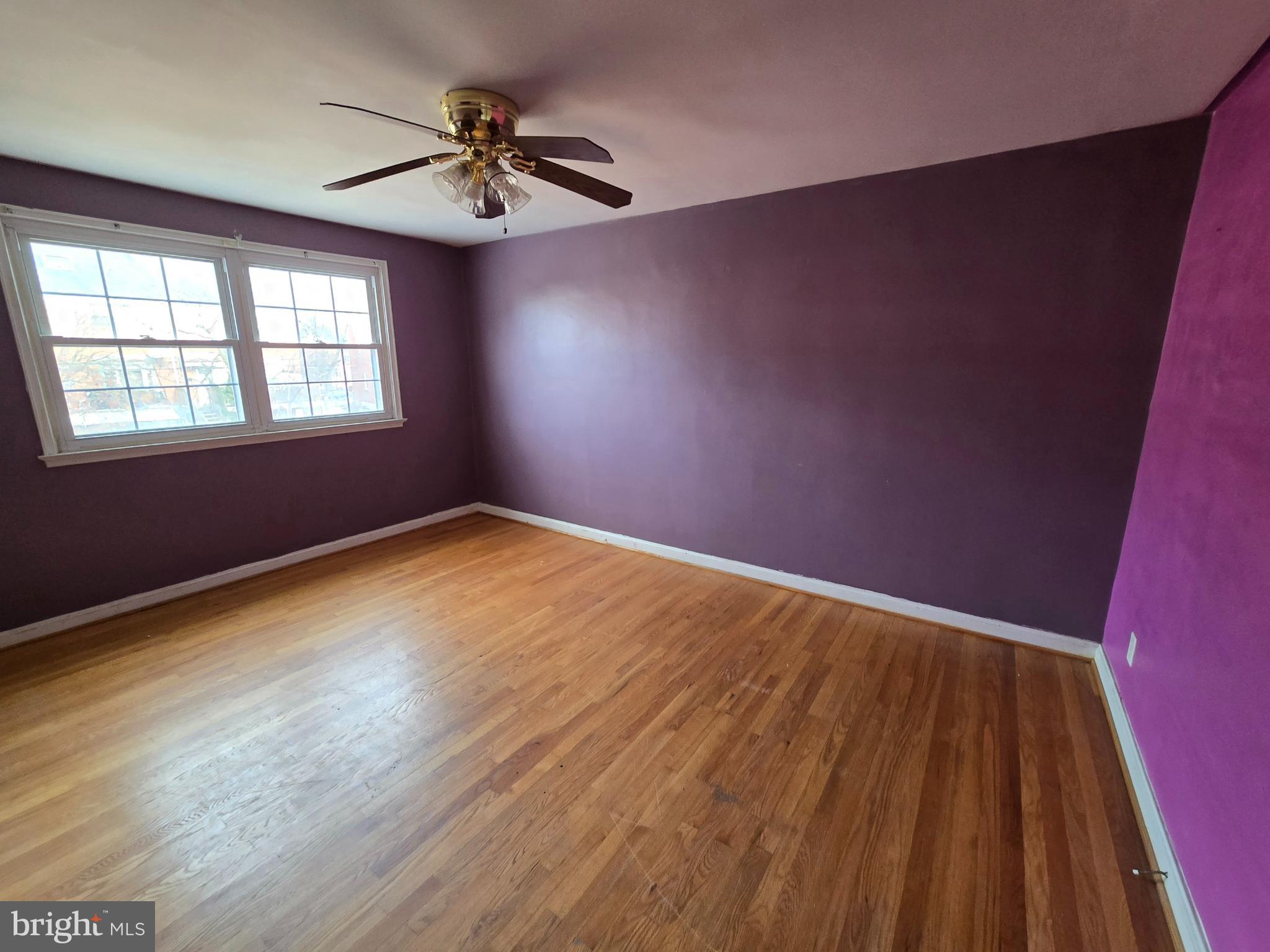 1708 Hartsdale Road Baltimore, MD 21239 - Photo 16 of 26 wooden floor in an empty room with a window