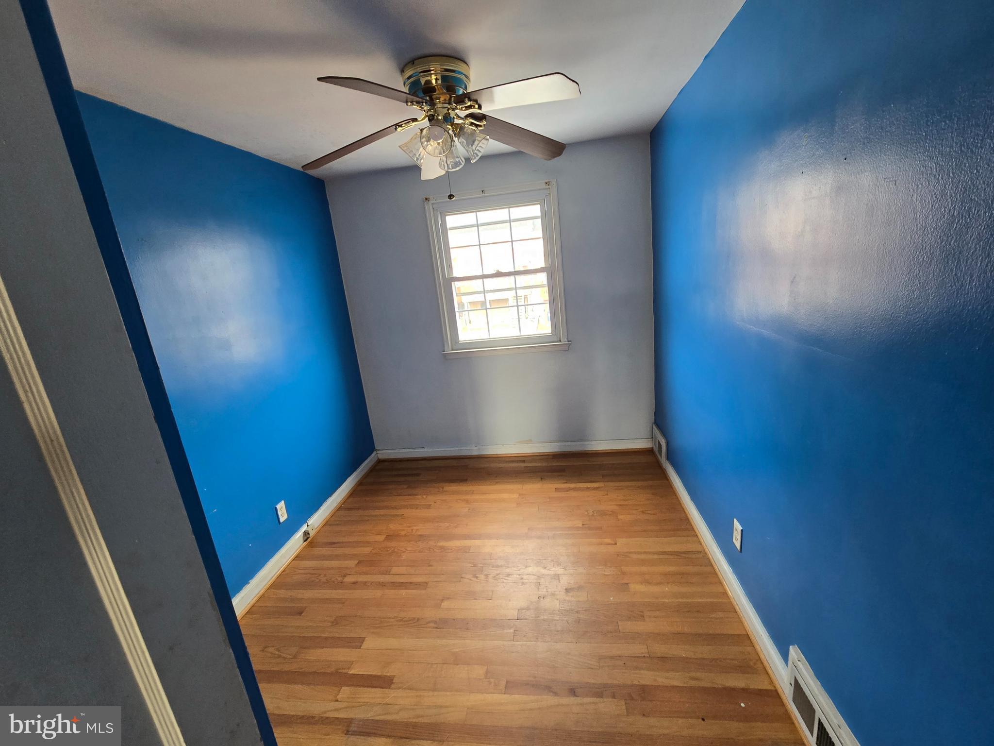 1708 Hartsdale Road Baltimore, MD 21239 - Photo 17 of 26 wooden floor in an empty room with a window