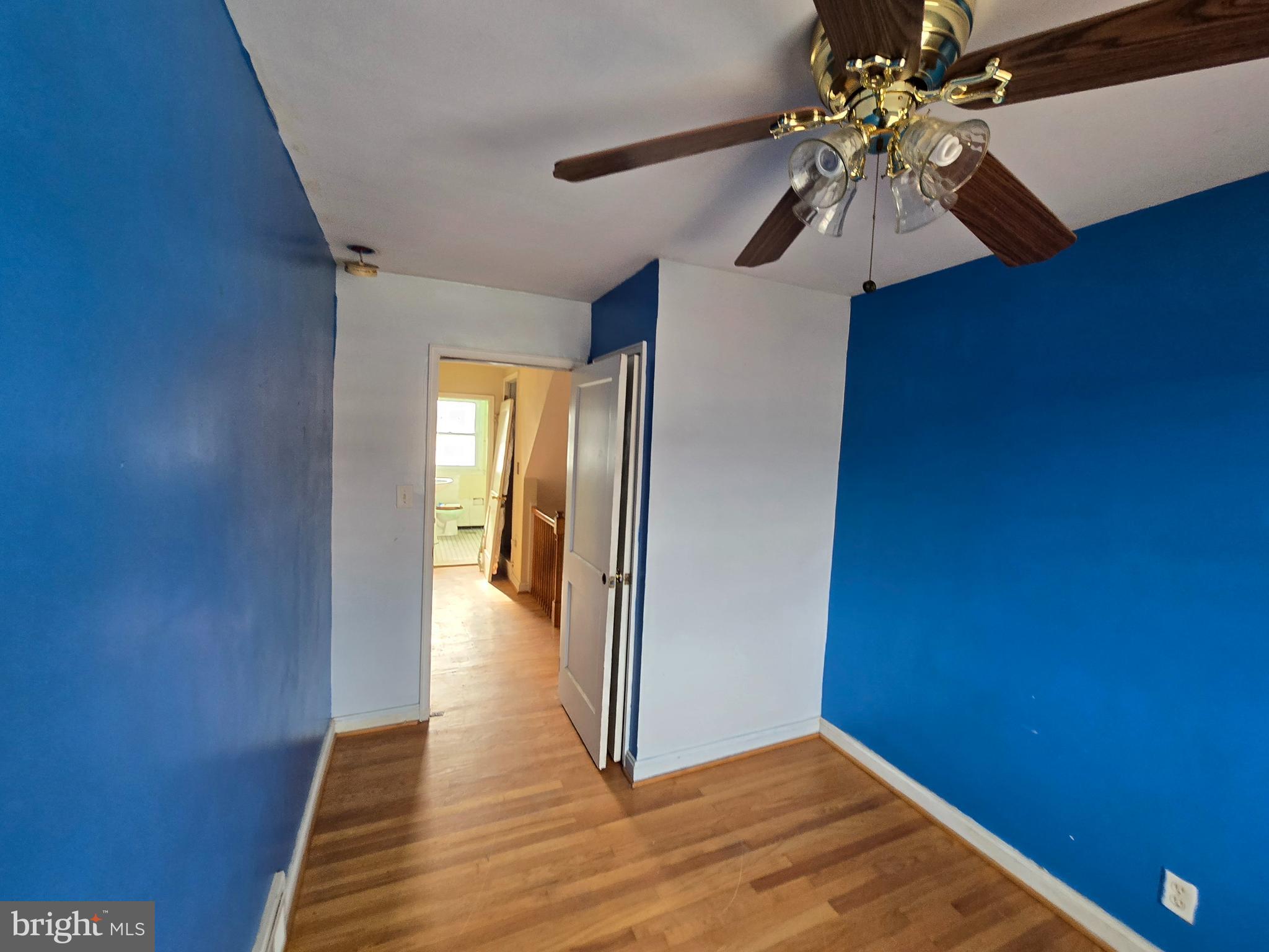 1708 Hartsdale Road Baltimore, MD 21239 - Photo 19 of 26 a view of a hallway with wooden floor and a chandelier