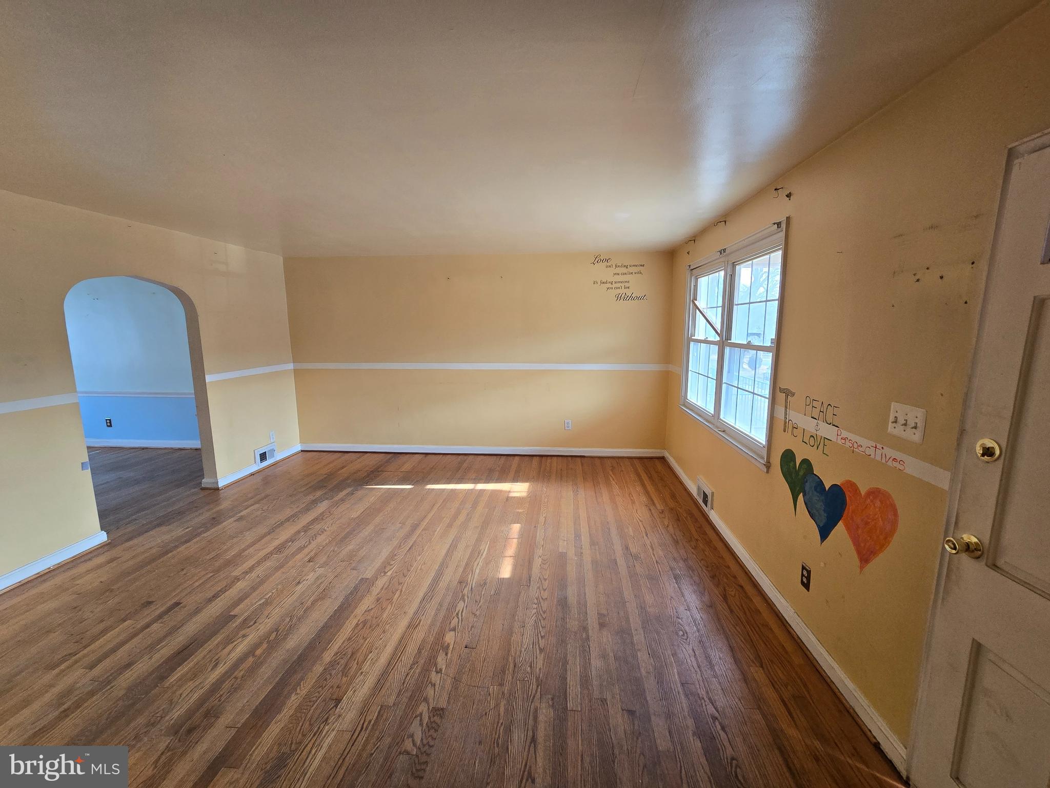 1708 Hartsdale Road Baltimore, MD 21239 - Photo 2 of 26 wooden floor in an empty room with a window