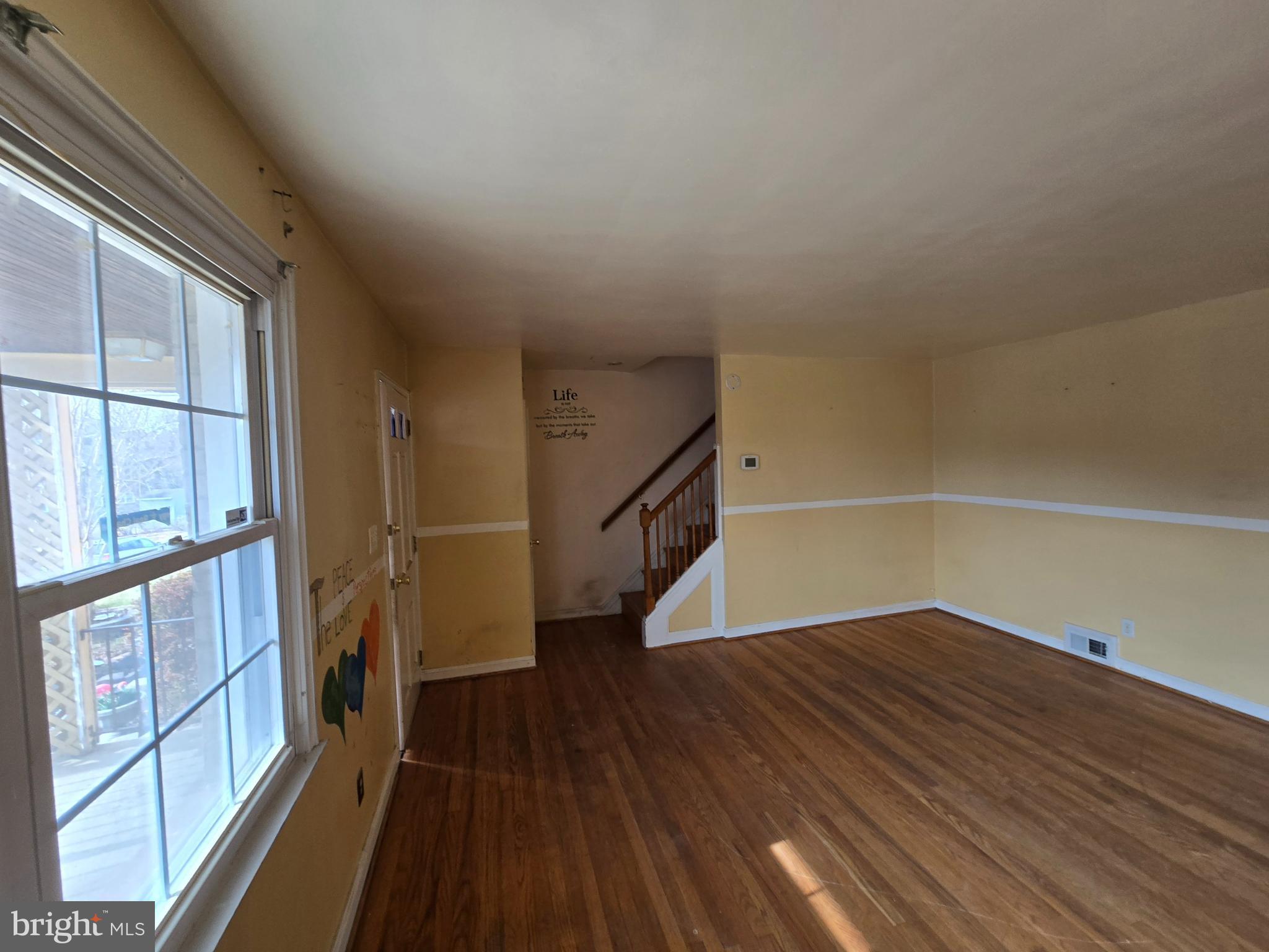 1708 Hartsdale Road Baltimore, MD 21239 - Photo 3 of 26 a view of a hallway with wooden floor and staircase