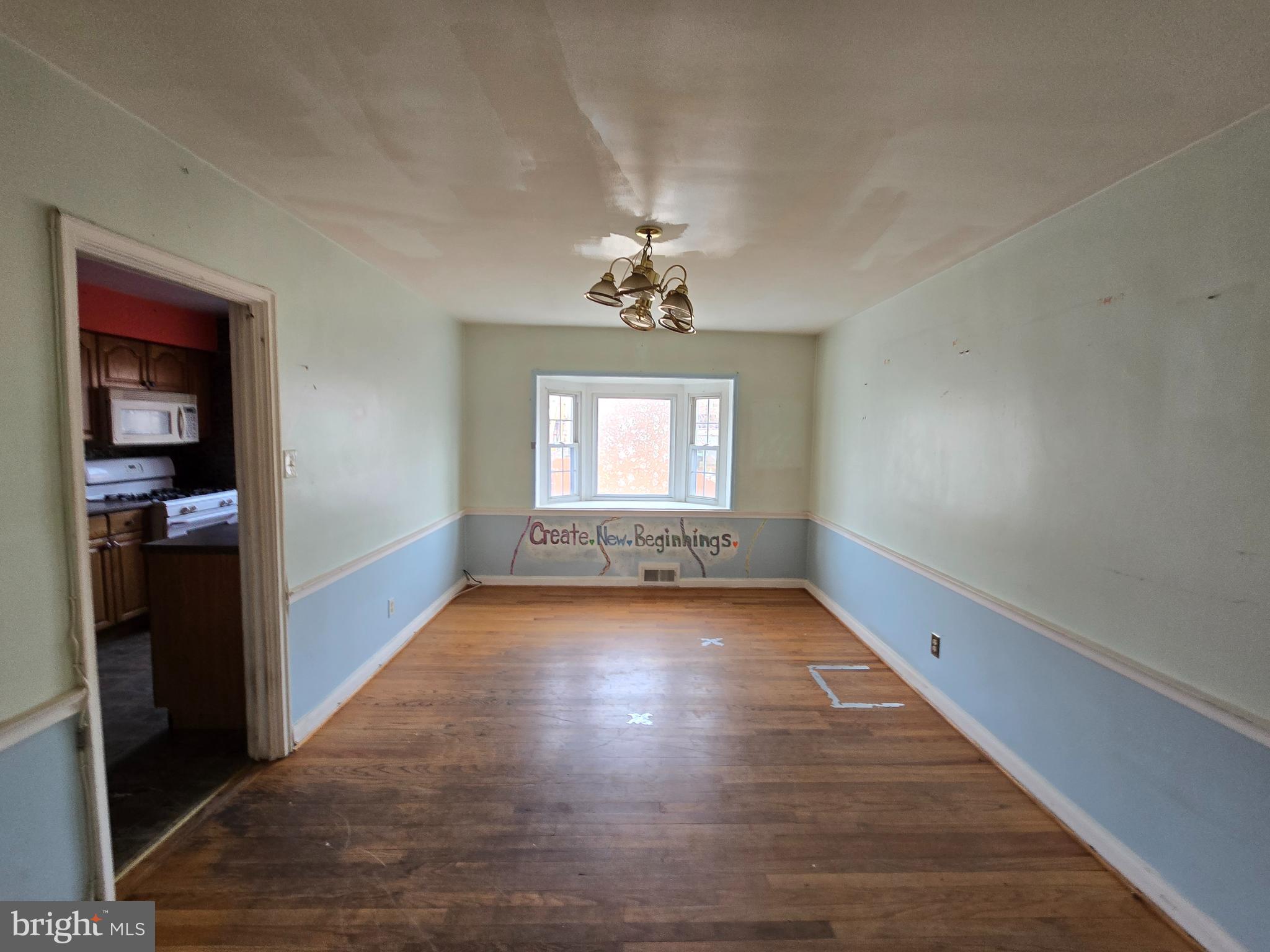 1708 Hartsdale Road Baltimore, MD 21239 - Photo 7 of 26 wooden floor in an empty room with a window
