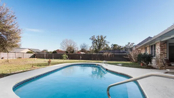 a view of a swimming pool with an outdoor seating