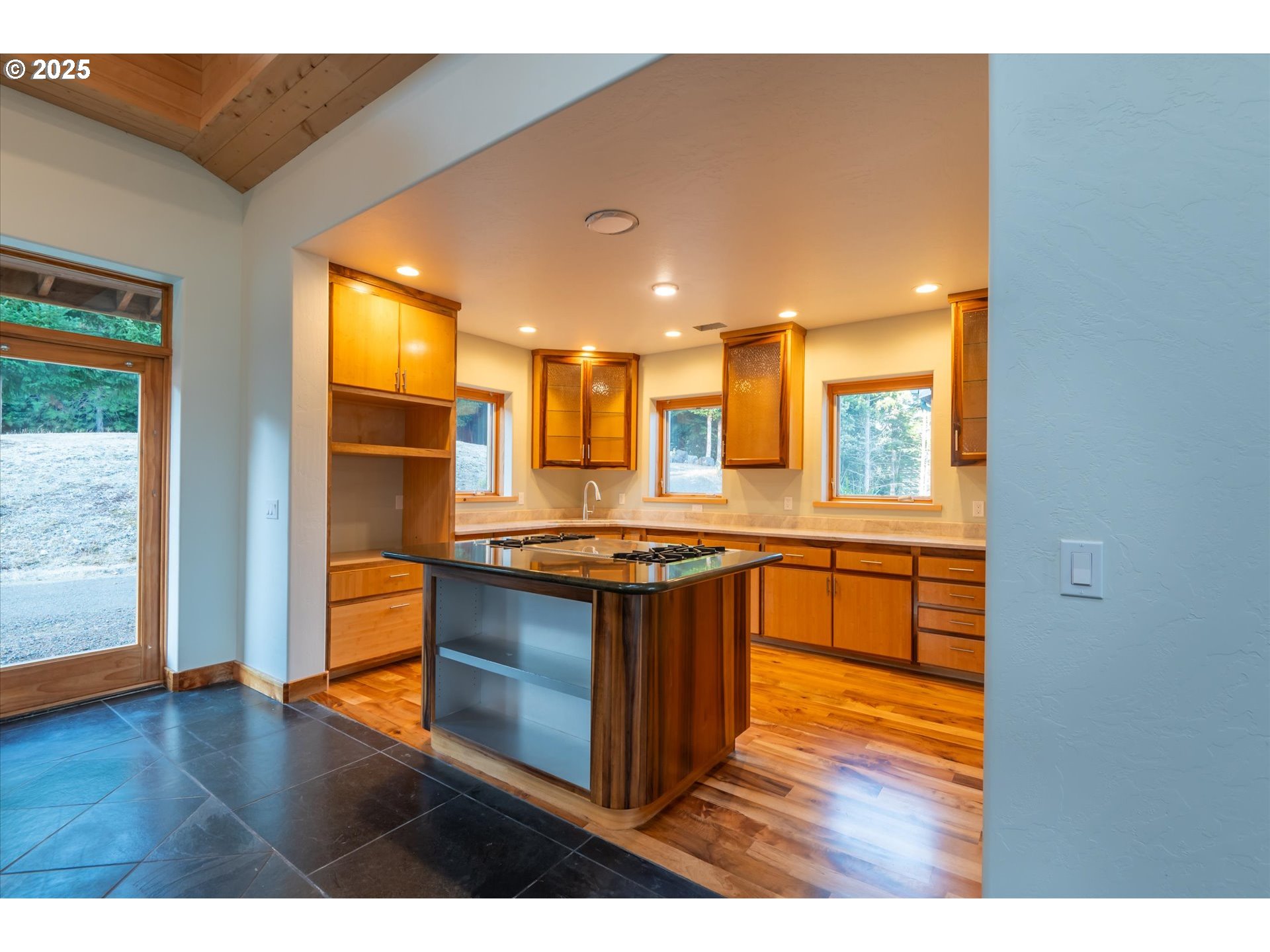 32855 Miller Ranch Road Gold Beach, OR 97444 - Photo 20 of 47 a kitchen with stainless steel appliances granite countertop a stove and a view of living room
