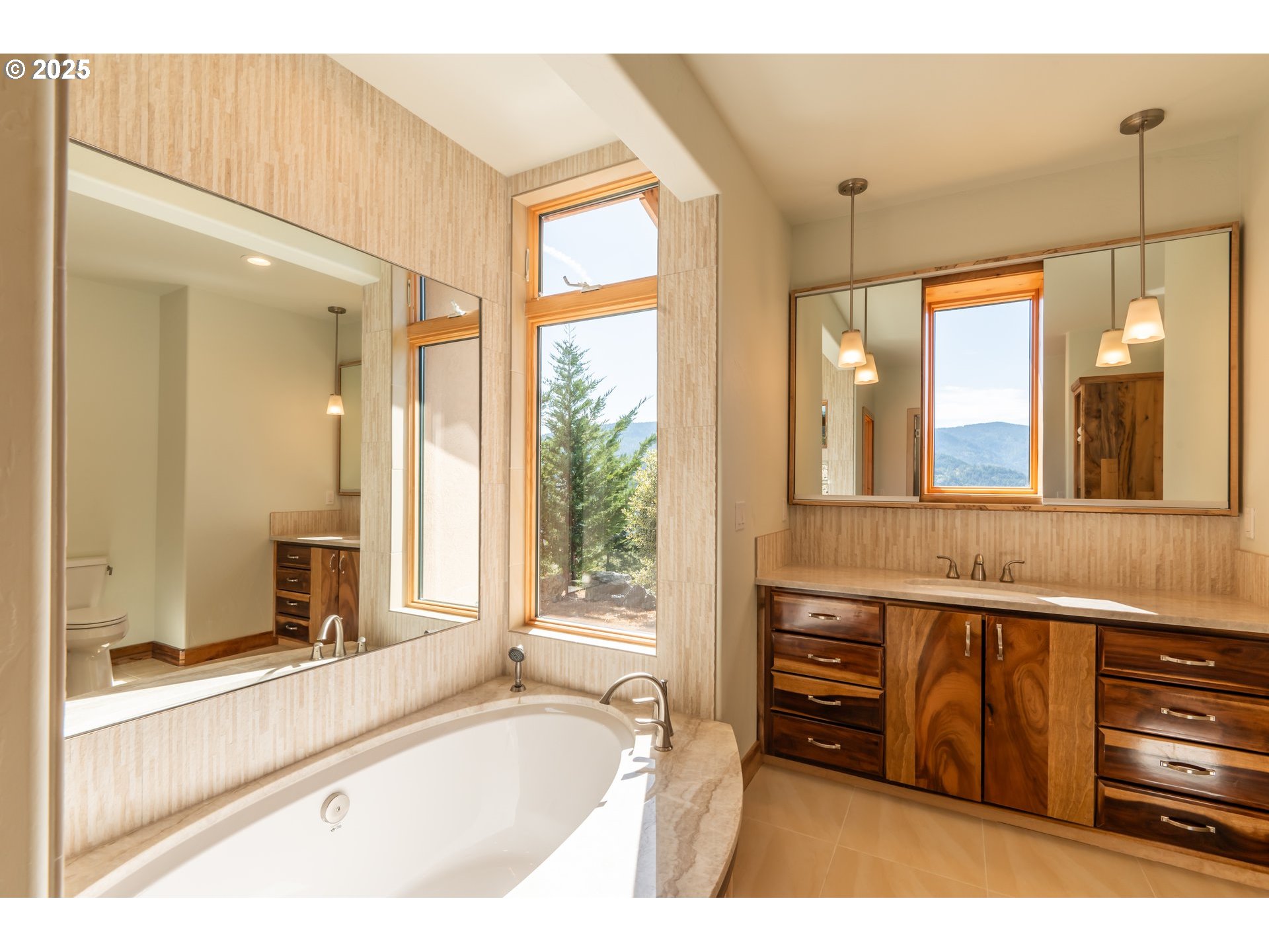 32855 Miller Ranch Road Gold Beach, OR 97444 - Photo 31 of 47 a spacious bathroom with a tub and a large mirror