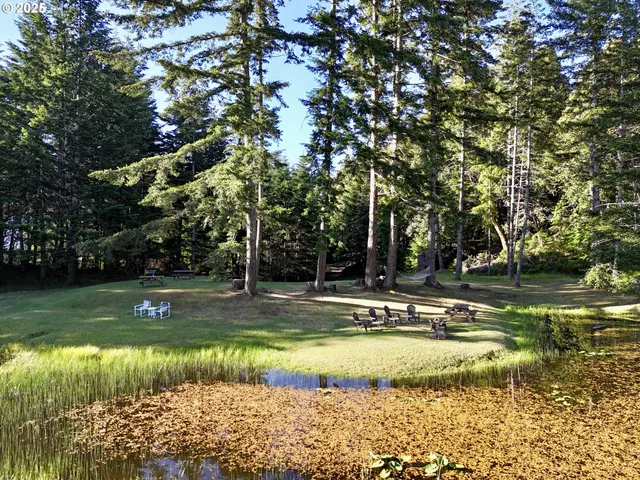 a backyard of a house with table and chairs