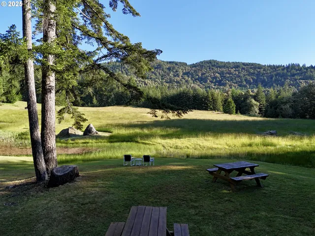 a backyard of a house with table and chairs