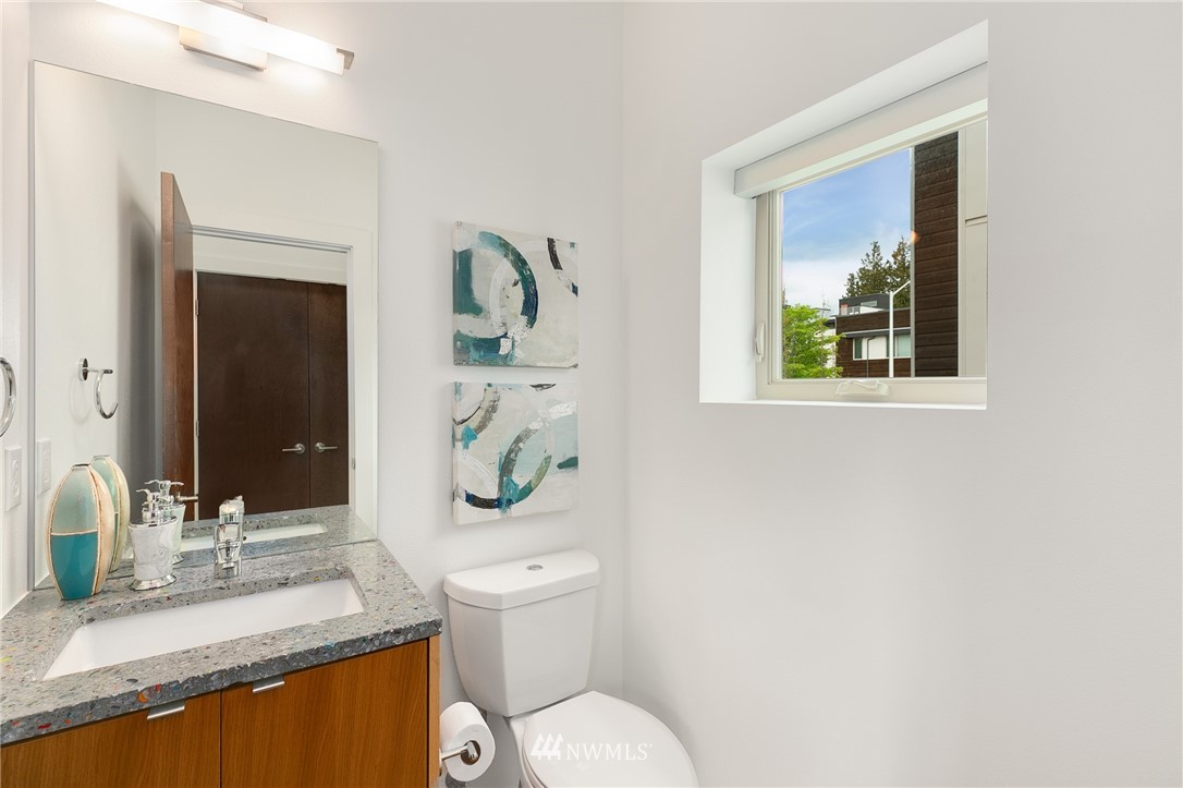 4455 Renton Avenue South Seattle, WA 98108 - Photo 14 of 25 a bathroom with a granite countertop sink mirror vanity and toilet