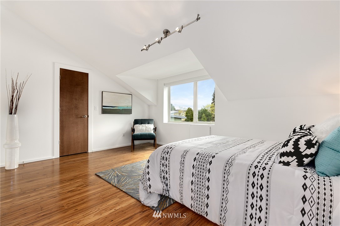 4455 Renton Avenue South Seattle, WA 98108 - Photo 15 of 25 a bedroom with a bed and wooden floor