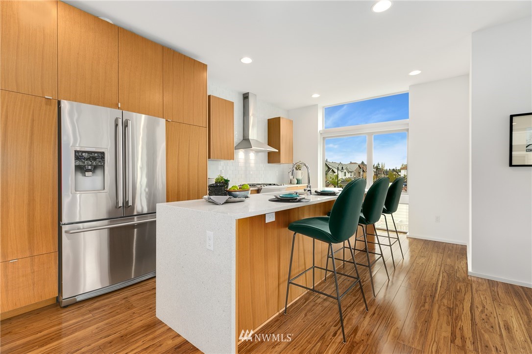 4455 Renton Avenue South Seattle, WA 98108 - Photo 4 of 25 a kitchen with stainless steel appliances granite countertop a refrigerator a sink dishwasher and a stove with wooden floor