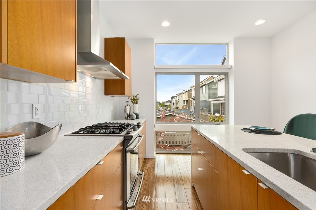 4455 Renton Avenue South Seattle, WA 98108 - Photo 5 of 25 a kitchen with stainless steel appliances granite countertop a sink and a stove