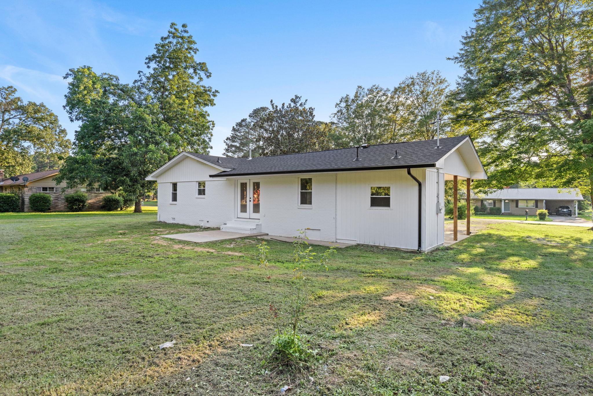 17 County Road 233 Corinth, MS 38834 - Photo 25 of 40 Rear view of house with a yard, a patio, and french doors