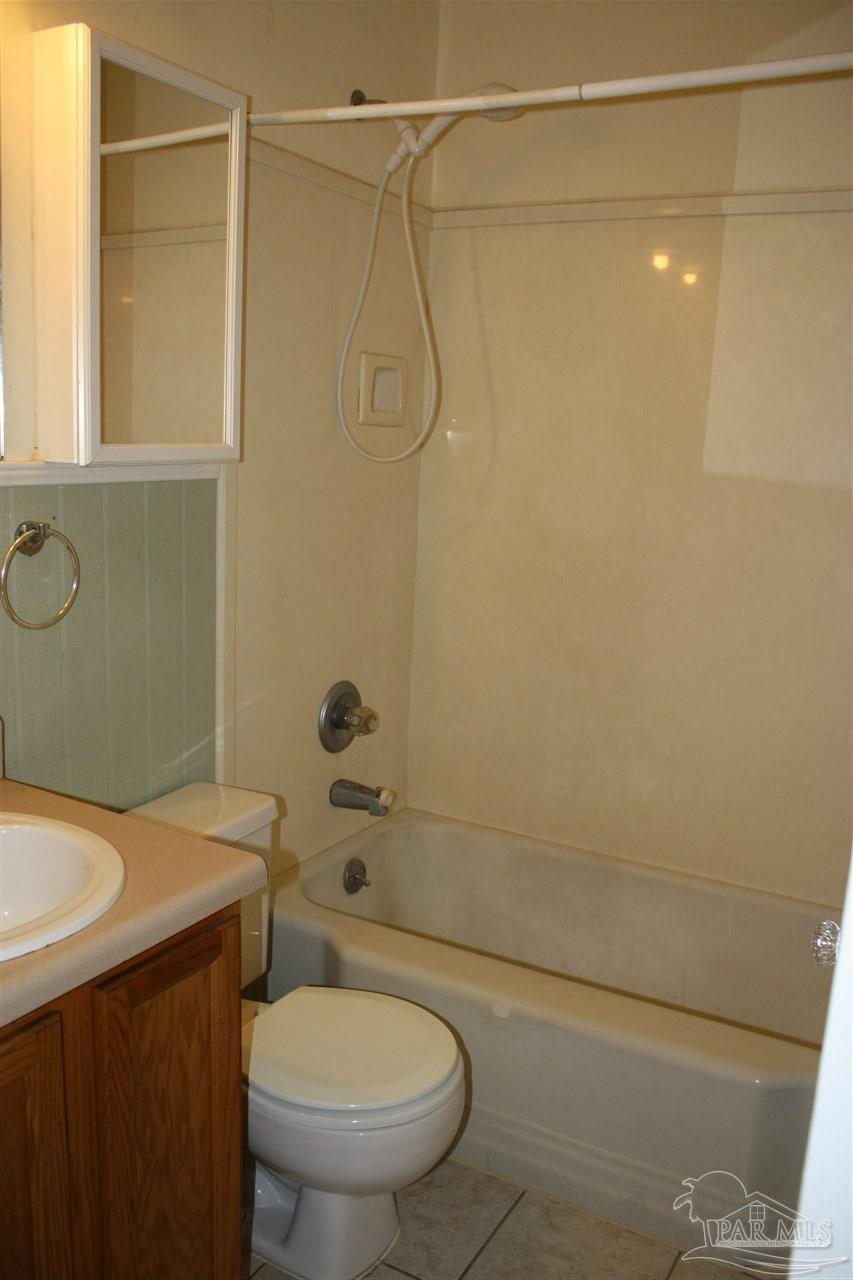 7195 Gillespie Road Milton, FL 32583 - Photo 11 of 14 a bathroom with a sink a toilet and shower