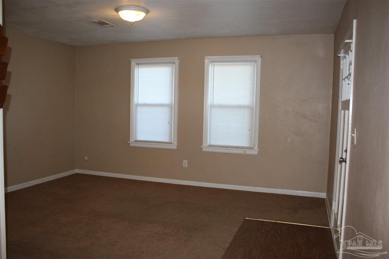 7195 Gillespie Road Milton, FL 32583 - Photo 4 of 14 an empty room with windows
