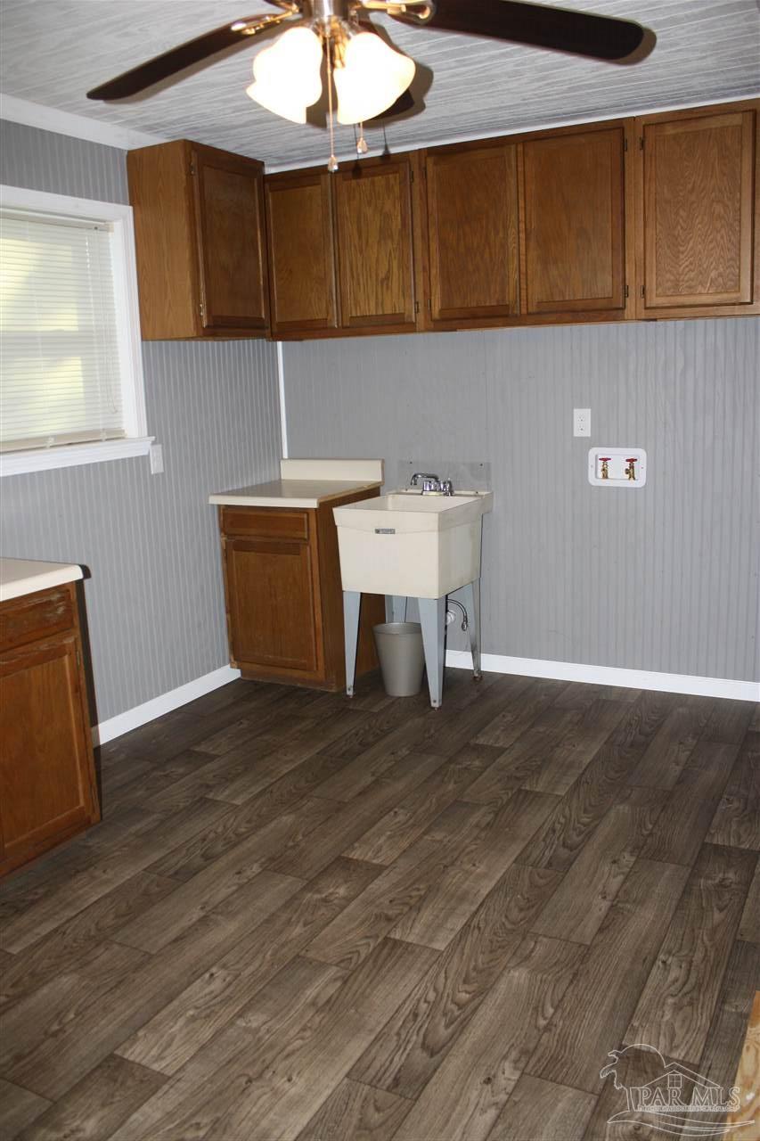 7195 Gillespie Road Milton, FL 32583 - Photo 9 of 14 a view of a kitchen with a sink and a microwave