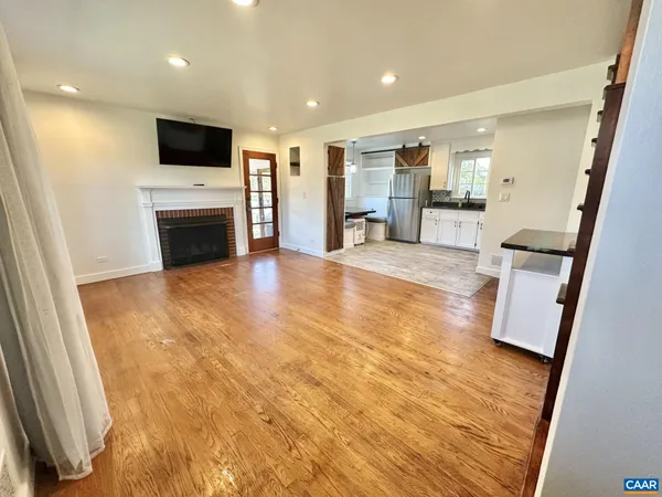 a view of open kitchen with furniture and fireplace