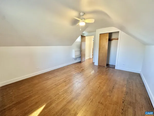 a view of a room with wooden floor