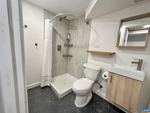 a white toilet sitting next to a bathroom sink