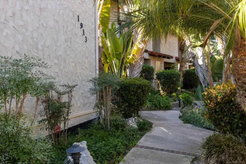 a front view of a house with a garden and yard