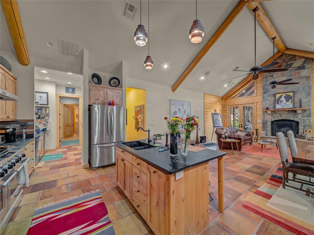 2197 Netherly Lane Forestburg, TX 76239 - Photo 15 of 40 a kitchen with stainless steel appliances granite countertop a sink a stove and a refrigerator