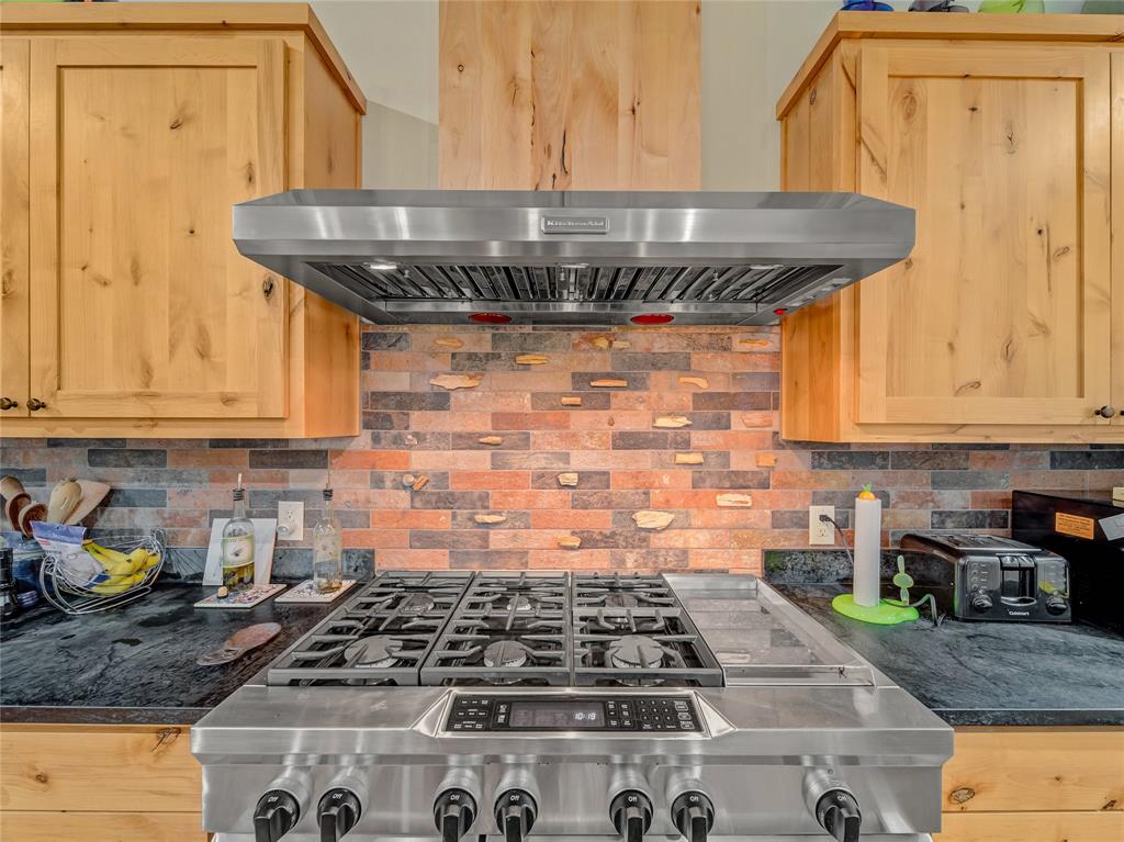 2197 Netherly Lane Forestburg, TX 76239 - Photo 17 of 40 a kitchen with granite countertop a stove and cabinets