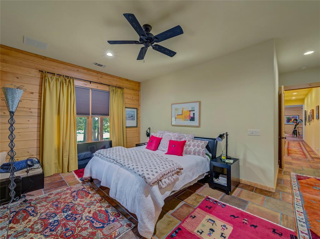 2197 Netherly Lane Forestburg, TX 76239 - Photo 21 of 40 a bedroom with a bed and a chandelier