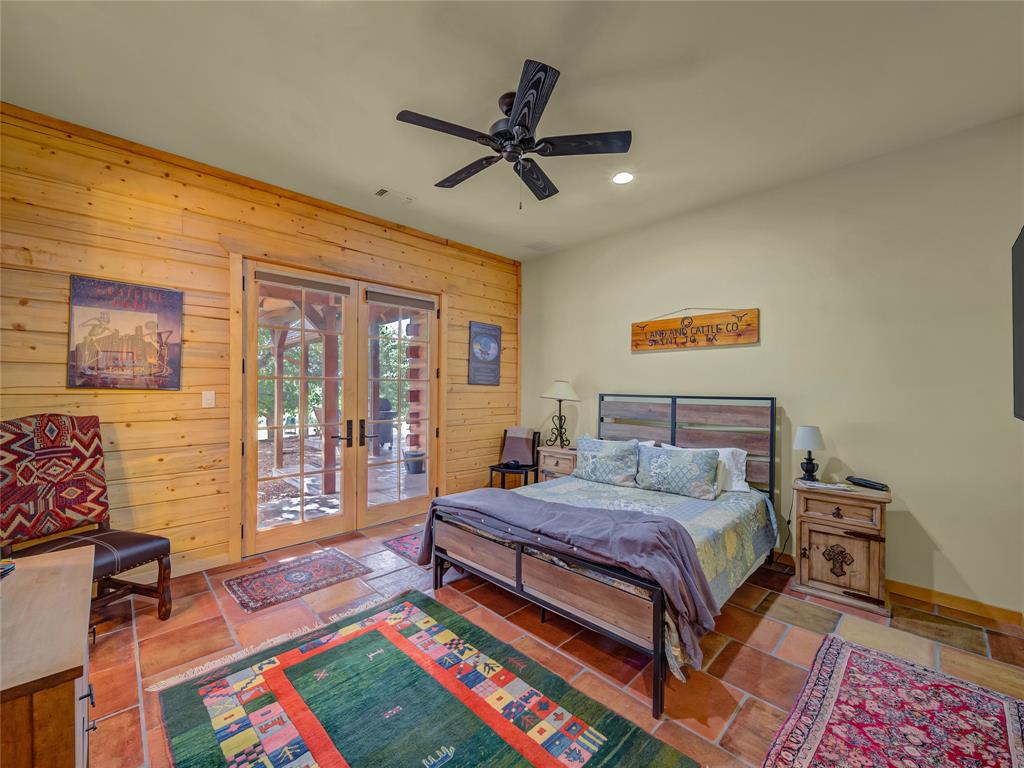 2197 Netherly Lane Forestburg, TX 76239 - Photo 22 of 40 a bedroom with a bed and a chandelier