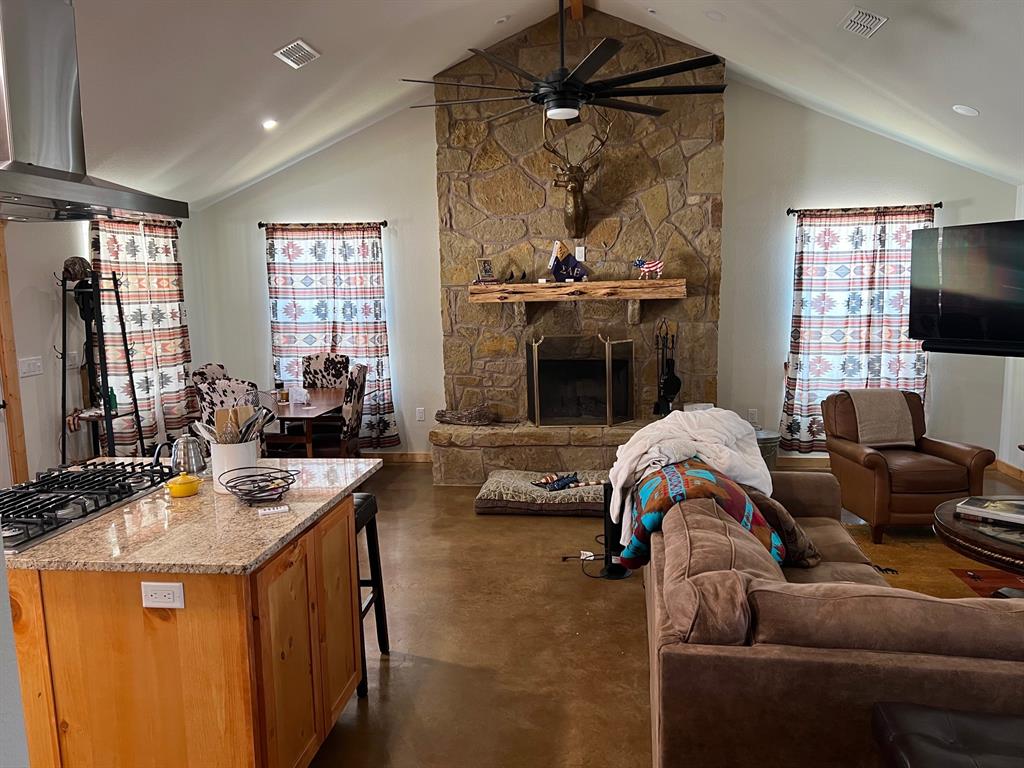 2197 Netherly Lane Forestburg, TX 76239 - Photo 27 of 40 a living room with furniture a flat screen tv and a fireplace