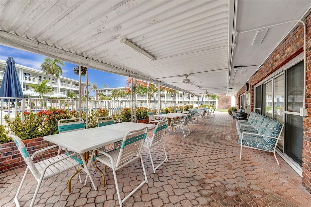 5203 Northeast 24th Terrace, Unit B204 Fort Lauderdale, FL 33308 - Photo 11 of 12 a outdoor space with lots of tables a garden and chairs