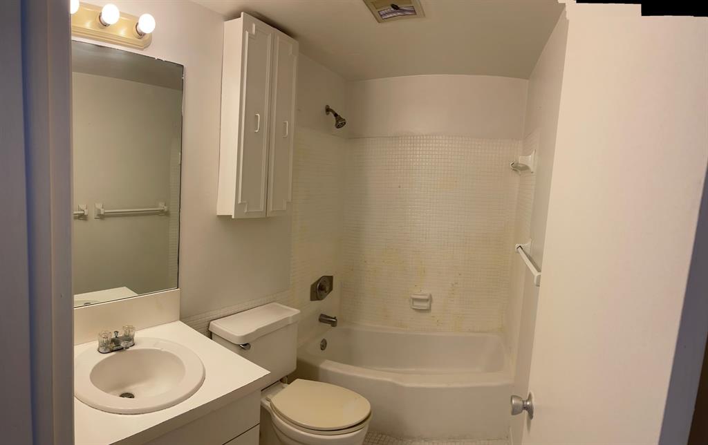 5203 Northeast 24th Terrace, Unit B204 Fort Lauderdale, FL 33308 - Photo 5 of 12 a bathroom with a sink toilet and shower